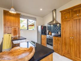 A kitchen with appliances and wooden fixtures at Alpine Retreat - Ohakune Holiday Home
