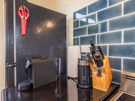 A kitchen with a refrigerator and coffee maker at Alpine Retreat - Ohakune Holiday Home Ohakune