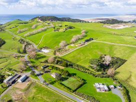 An aerial view of hills and farms at Mangawhai Heads Holiday Home in Mangawhai