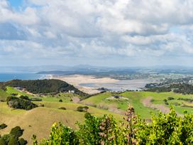 A view of hills, a river, and the ocean at Mangawhai Heads Holiday Home in Mangawhai