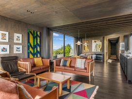 A living room with sofas and a coffee table at Mangawhai Heads Holiday Home in Mangawhai
