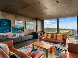 A living room with a couch and coffee table at Mangawhai Heads Holiday Home in Mangawhai