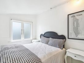 A bedroom with a bed and bedside table at Wellington Holiday home in Wellington