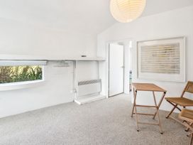 A room with a window, door, and furniture at Wellington Holiday home Wellington