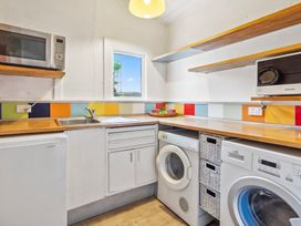 A kitchen with sink and appliances at Wellington Holiday home in Wellington