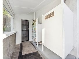 An entryway with a door and cabinets at Wellington Holiday home in Wellington