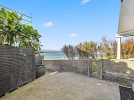 An outdoor area with a concrete patio and plants at Wellington Holiday home in Wellington
