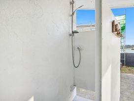 A shower with a door in a bathroom at Wellington Holiday home in Wellington
