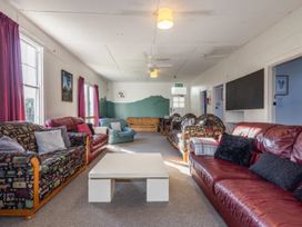 A lounge with sofas and a coffee table at Taylor Lodge Adventure Base - Erua Holiday Home National Park