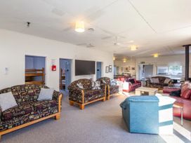 A common area with sofas and a coffee table at Taylor Lodge Adventure Base - Erua Holiday Home in National Park