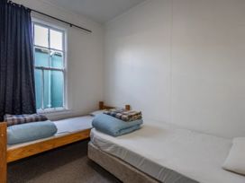 A bedroom with two beds and a window at Taylor Lodge Adventure Base - Erua Holiday Home National Park