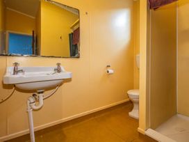 A bathroom with a sink, toilet, and shower at Taylor Lodge Adventure Base - Erua Holiday Home