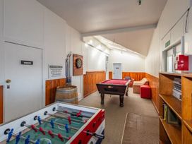 A game room with a foosball table and pool table at Taylor Lodge Adventure Base -  Erua Holiday Home National Park