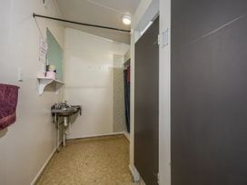 A bathroom with a sink and shower curtain at Taylor Lodge Adventure Base - Erua Holiday Home, National Park