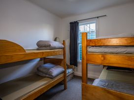 A bedroom with bunk beds and a window at Taylor Lodge Adventure Base - Erua Holiday Home National Park