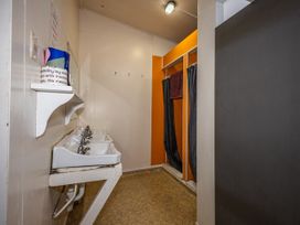 A bathroom with sinks and curtains at Taylor Lodge Adventure Base - Erua Holiday Home National Park