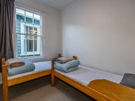 A bedroom with two beds and a window at Taylor Lodge Adventure Base - Erua Holiday Home