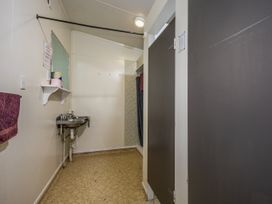 A bathroom with a sink and towel at Taylor Lodge Adventure Base - Erua Holiday Home National Park