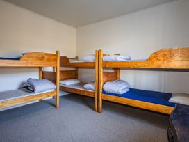 A bedroom with bunk beds and pillows at Taylor Lodge Adventure Base - Erua Holiday Home National Park