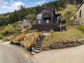 A house with stairs and plants at Alpine Luxe - Queenstown Holiday Home in Queenstown