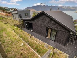 An outdoor view of houses with mountains and water at Alpine Luxe - Queenstown Holiday Home Queenstown