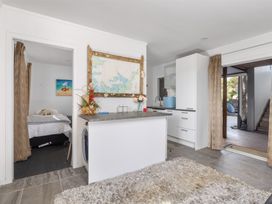 A kitchen with a map on the wall at Coastal Serenity - Te Tii Escape