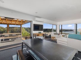 A living room with a sofa and coffee table at Coastal Serenity - Te Tii Escape