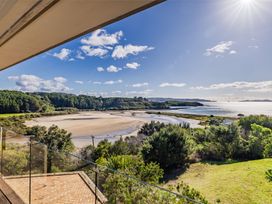 A coastal view with water and trees at Coastal Serenity - Te Tii Escape