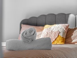 A bed with towels and pillows at Hamilton in Hamilton