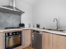 A kitchen with appliances including a stove, oven, and sink at Hamilton in Hamilton