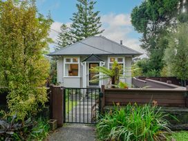 A house with garden and gate at Birdsong Retreat - Titirangi Holiday Home Auckland