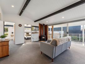A living room with a sofa and fireplace at The Cozy Corner - Taupo Holiday Home Acacia Bay