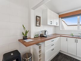 A kitchen with a counter, sink, and coffee maker at The Cozy Corner - Taupo Holiday Home in Acacia Bay