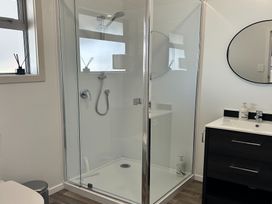 A bathroom with a shower and sink at The Cozy Corner - Taupo Holiday Home in Acacia Bay