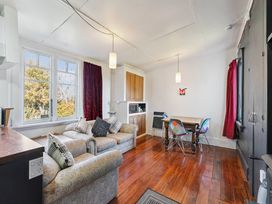 A living room with a sofa and dining table at Ohakune in Ohakune