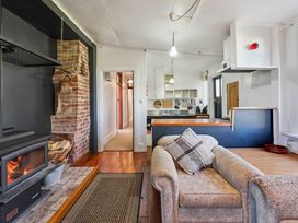 A living room with a fireplace and sofa at Ohakune in Ohakune