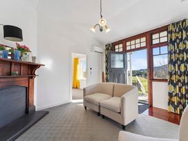A living room with a sofa and fireplace at Ohakune