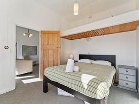A bedroom with a bed and nightstand at Ohakune