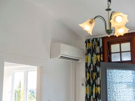 An indoor space with an air conditioner and a window at Ohakune