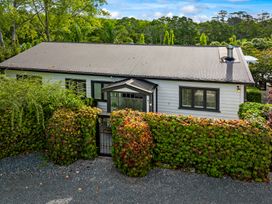 A house with a garden and stone driveway at Matakana in Warkworth