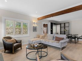 A living room with a sofa and coffee table at Board and Batten - Matakana Holiday Home in Matakana