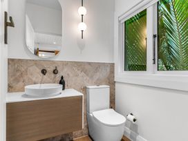 A bathroom with a sink and toilet at Board and Batten - Matakana Holiday Home, Matakana