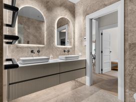 A bathroom with sinks and mirrors at Board and Batten - Matakana Holiday Home in Matakana