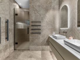 A bathroom with sinks and a shower at Board and Batten - Matakana Holiday Home