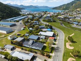 An aerial view of a residential area with houses and a marina at Bayview Haven - Waikawa Retreat Picton