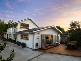 A house with a deck and outdoor furniture at Bayview Haven - Waikawa Retreat in Picton