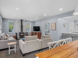 A living room with a fireplace and seating at Bayview Haven - Waikawa Retreat, Picton