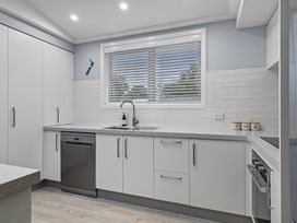 A kitchen with cabinets and a sink at Bayview Haven - Waikawa Retreat in Picton