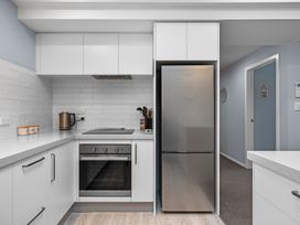 A kitchen with a refrigerator, oven, and kettle at Bayview Haven - Waikawa Retreat in Picton