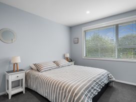 A bedroom with a bed and bedside tables at Bayview Haven - Waikawa Retreat Picton